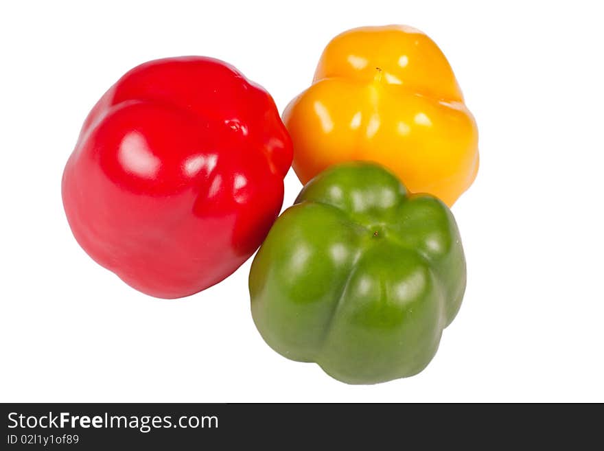 Three colorful pepper back isolated in white