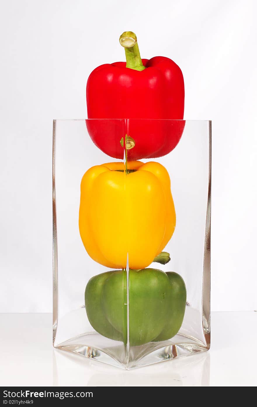 Fresh and delicious stoplight bell peppers in vase. Fresh and delicious stoplight bell peppers in vase