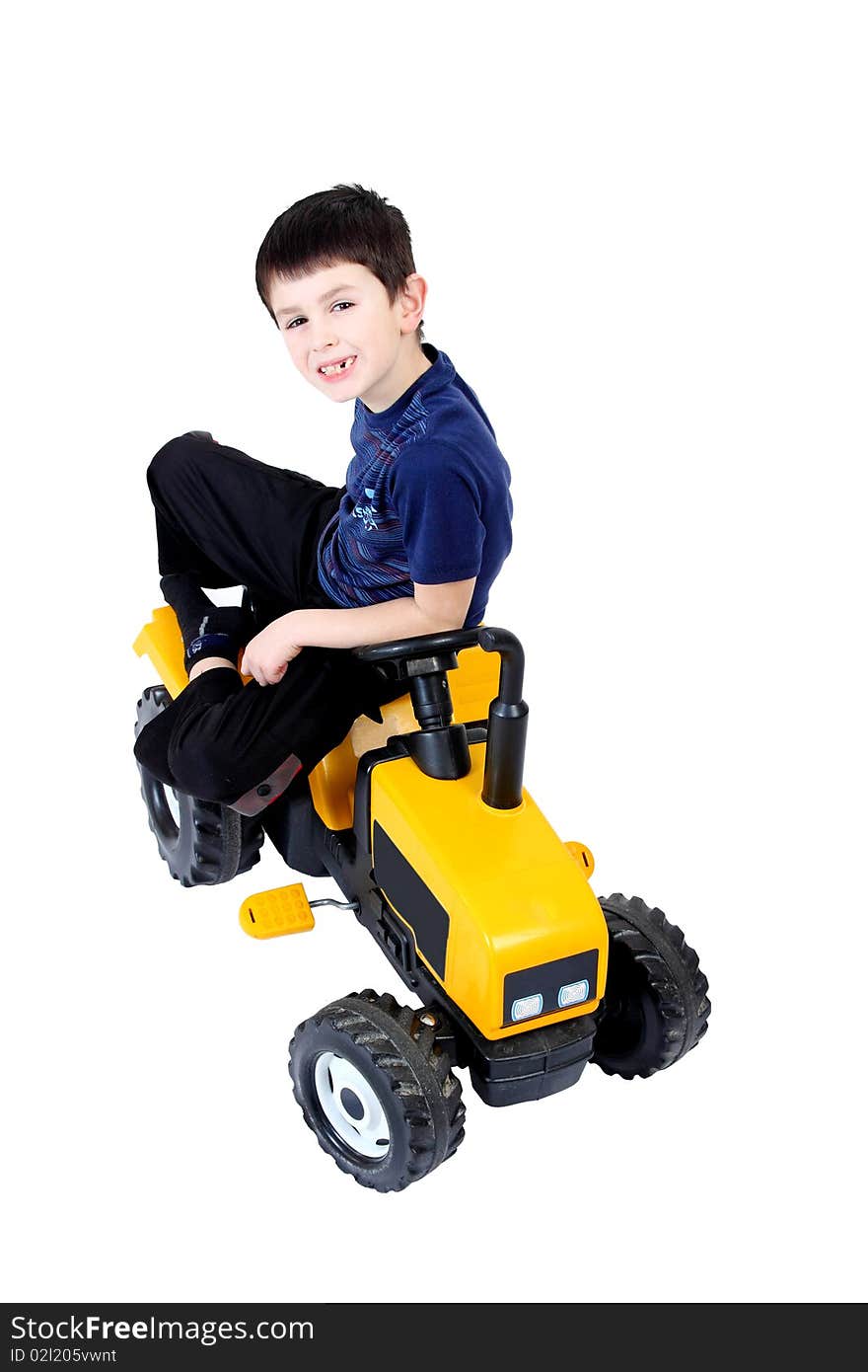 Small boy on the yellow tractor isolated on white background