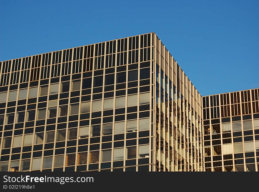 A modern office building with a blue sky