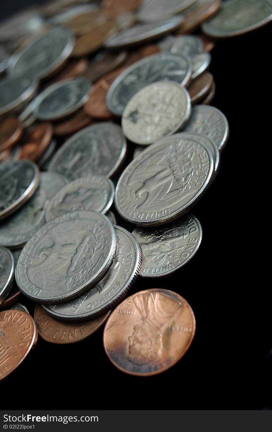 A whole bunch of American coins piled on top of one another to make this background. Shallow depth of field. A whole bunch of American coins piled on top of one another to make this background. Shallow depth of field.