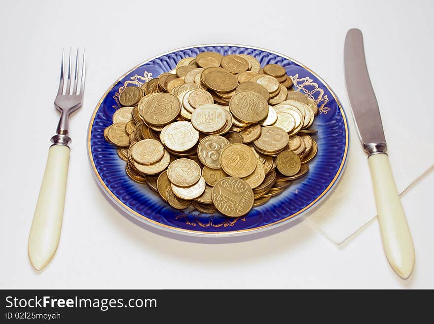 Plate of coins on white background