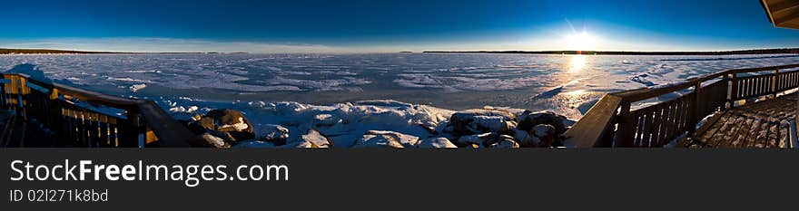 Panoramic view of sea gulf covered with ice