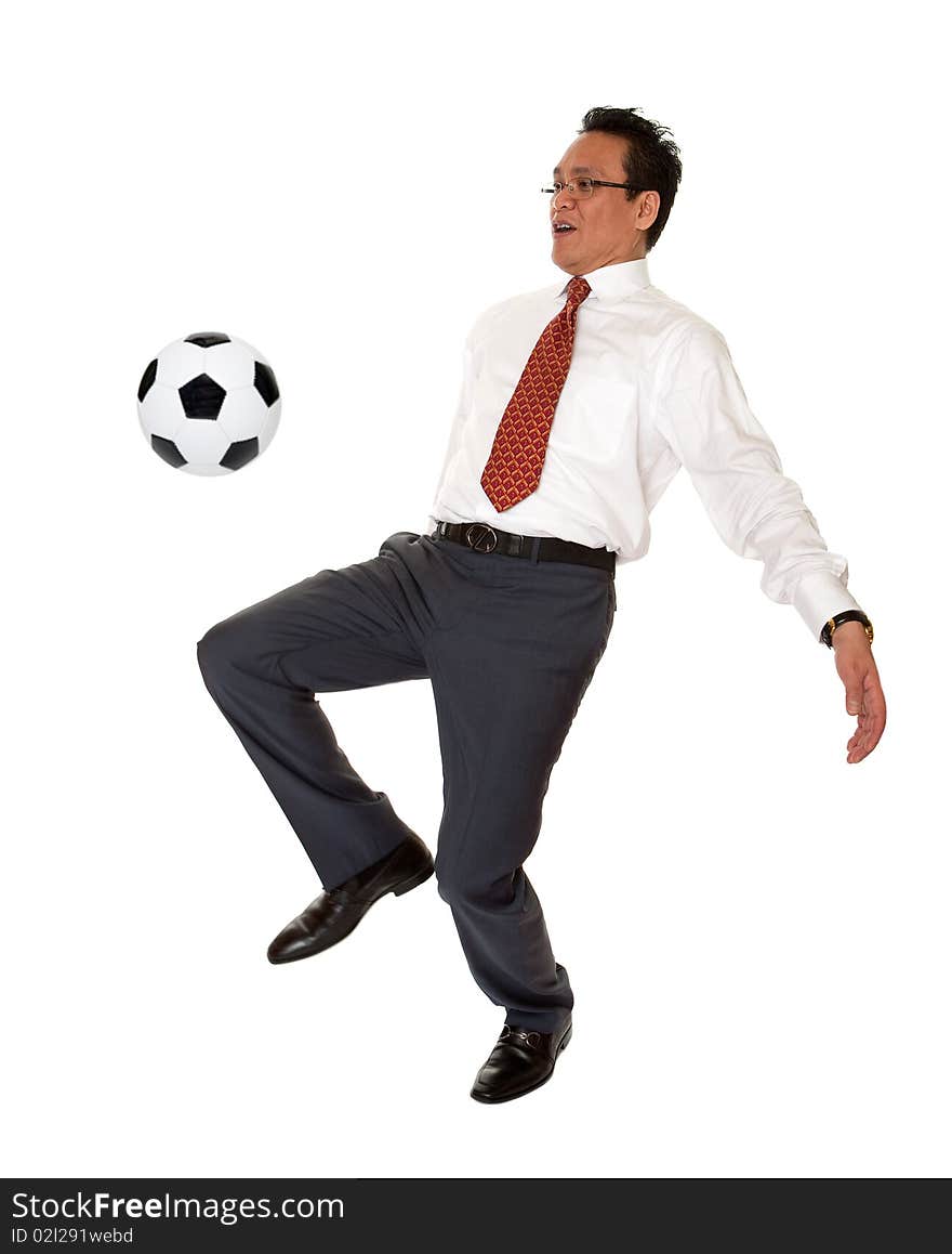 Businessman plays soccer, sport in the elegant suit before white background