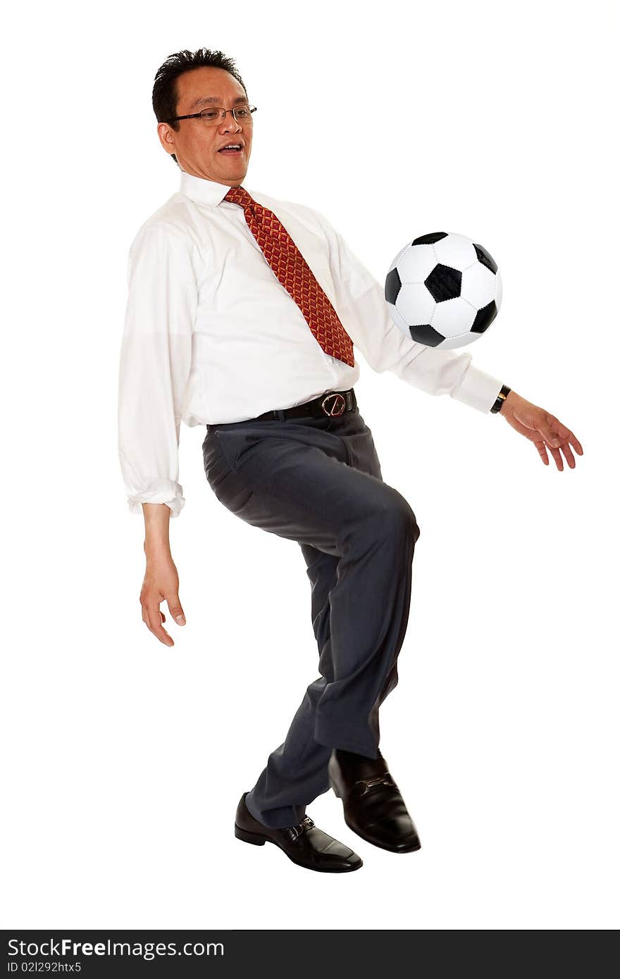 Businessman plays soccer, sport in the elegant suit before white background