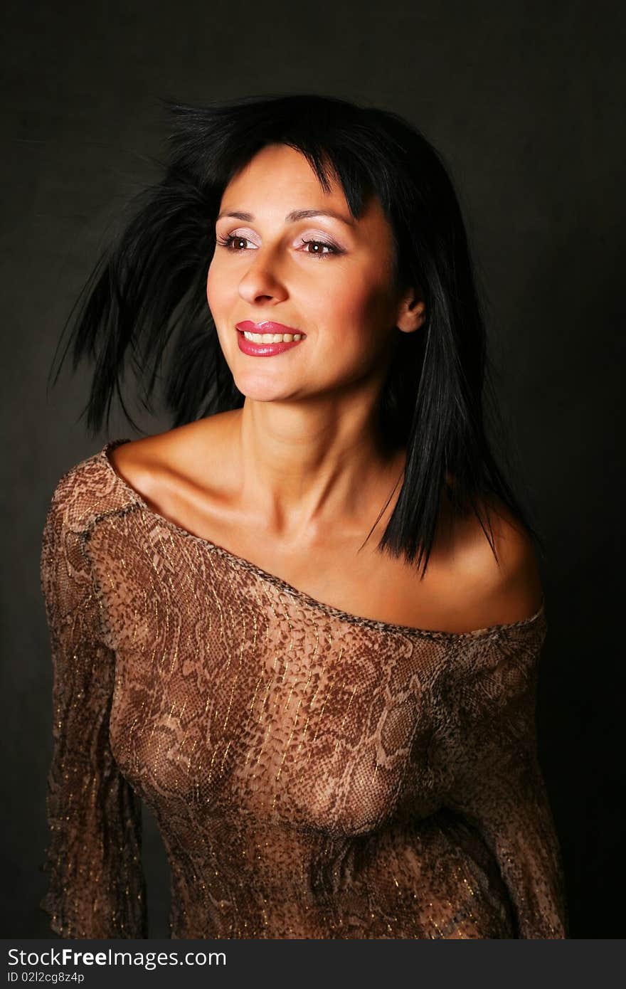 Portrait of a beautiful brunette on a dark background. Portrait of a beautiful brunette on a dark background