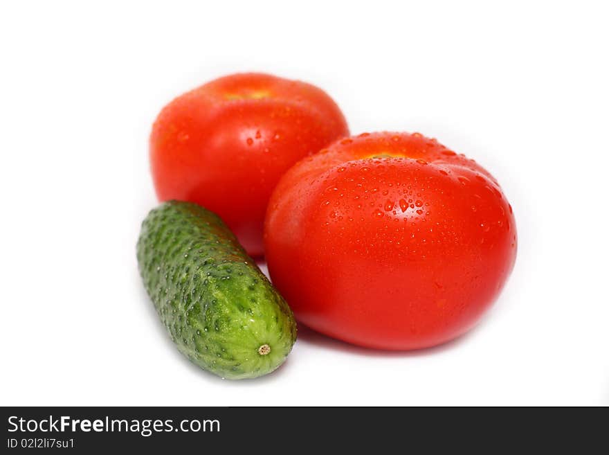 Red tomato and cucumber isolated on white background