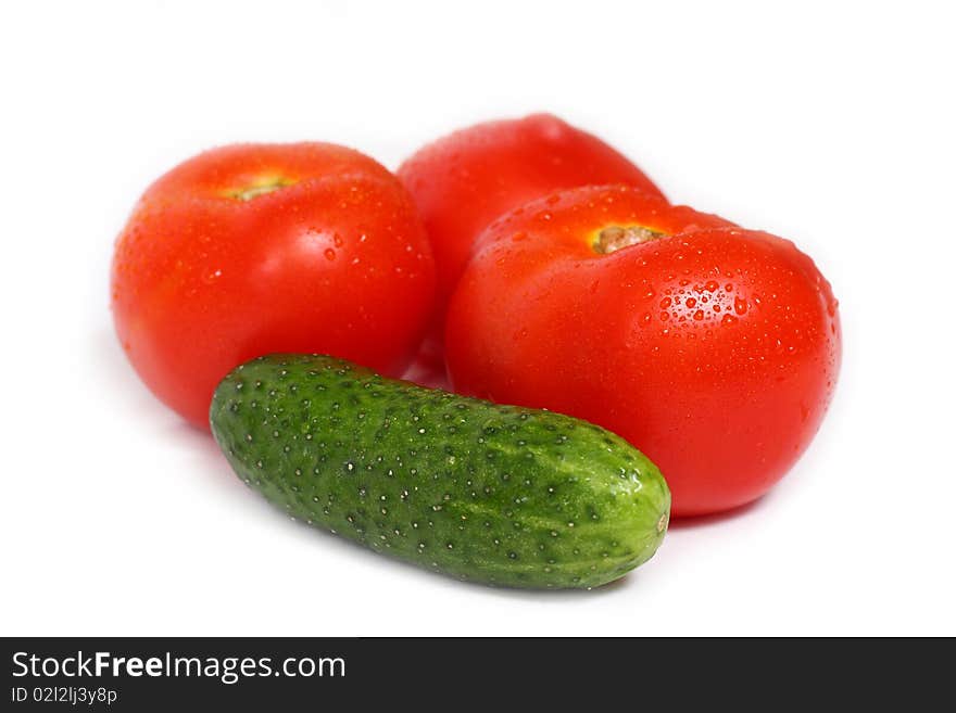 Red tomato and cucumber isolated on white background