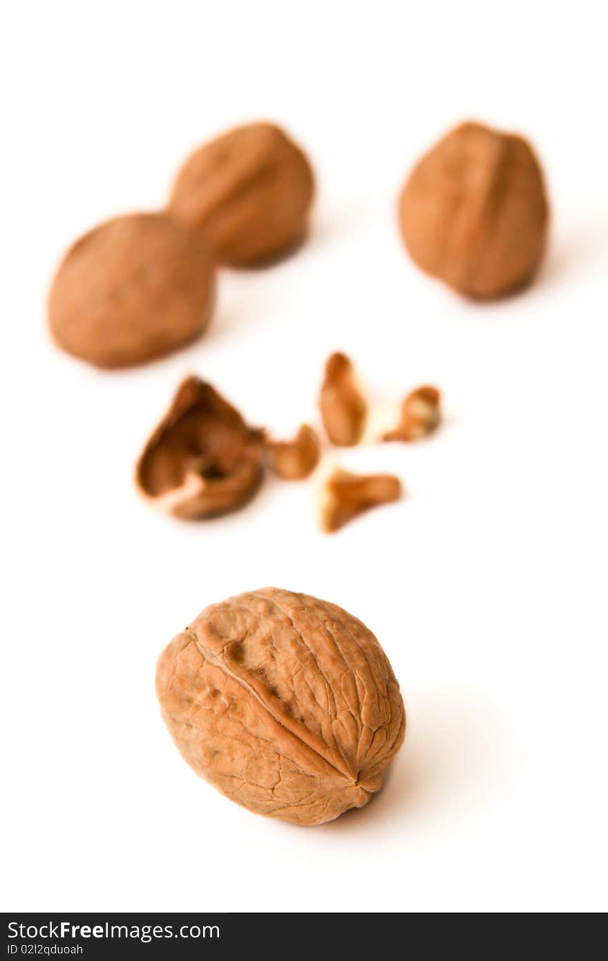 Cracked walnuts close up isolated on white background