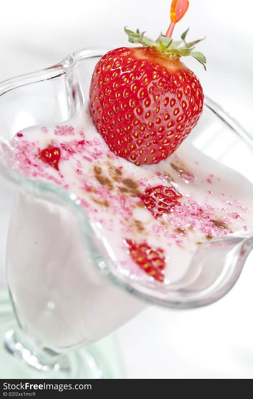 Milk shake with strawberries on white table top