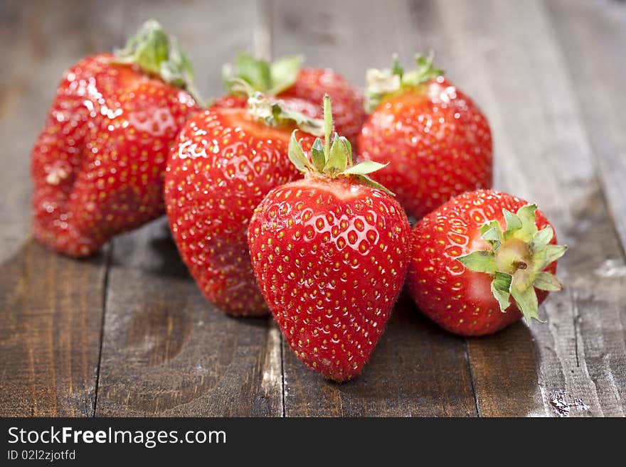 Heap of fresh strawberries on dark wooden table top. Heap of fresh strawberries on dark wooden table top