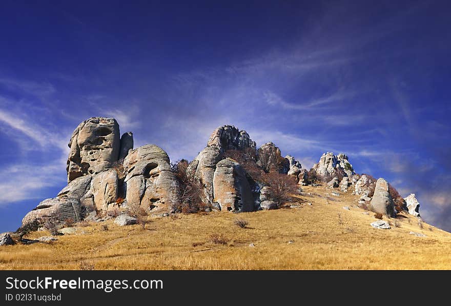 Rock on peak of the mountain with dark blue sky