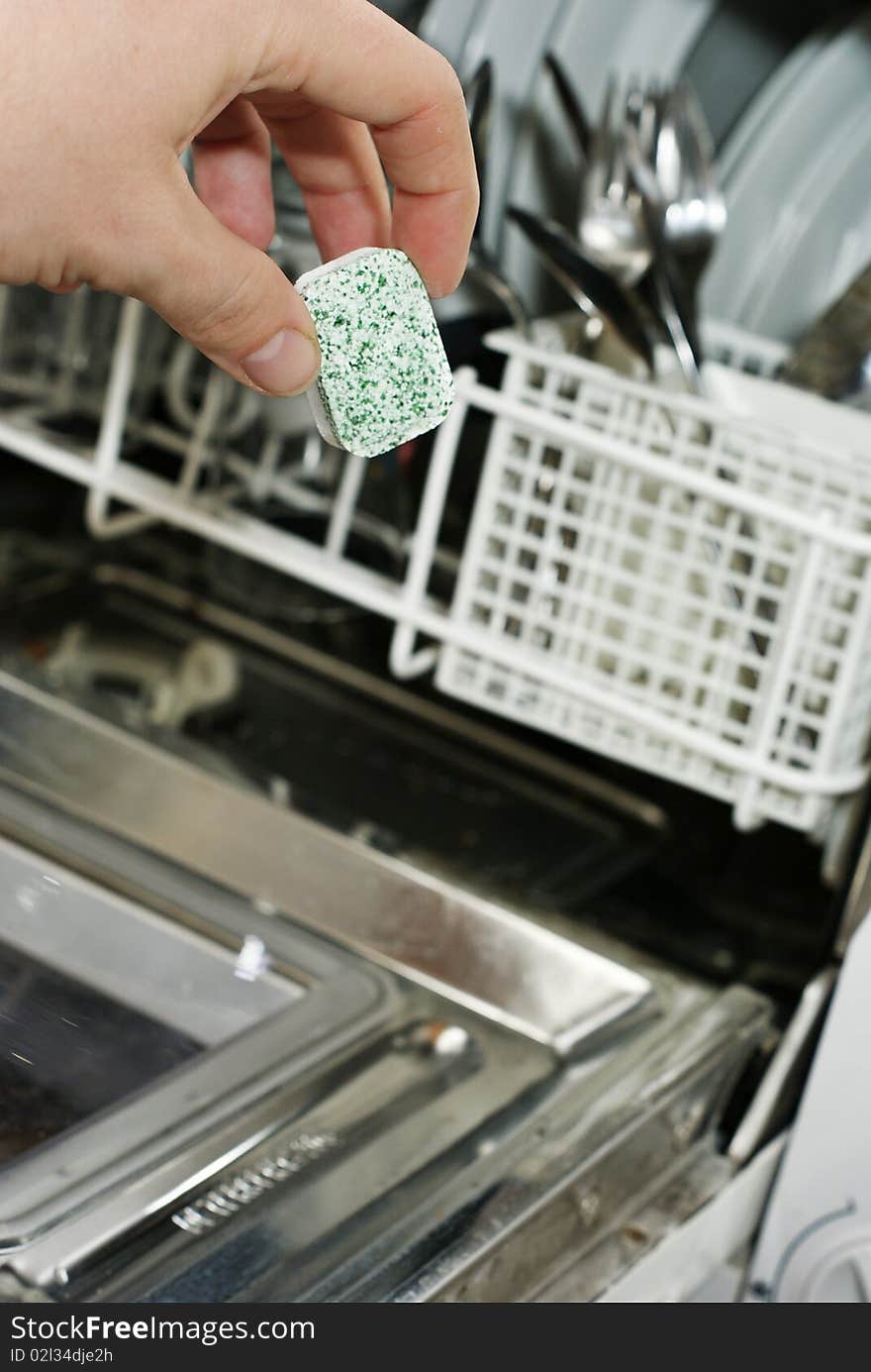 Placing soap in a dishwasher. Placing soap in a dishwasher