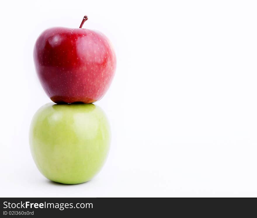 Red and green apple on white background. Space to insert text or design. Concepts: Food, Nutrition & Wellness