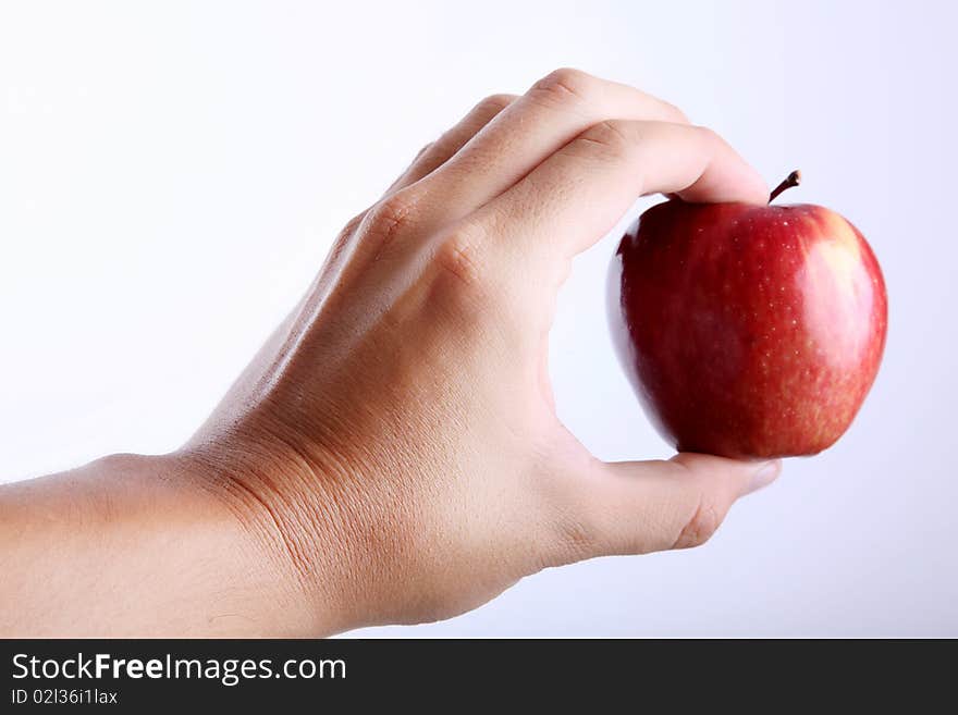 Red apple on hand over white background. Red apple on hand over white background