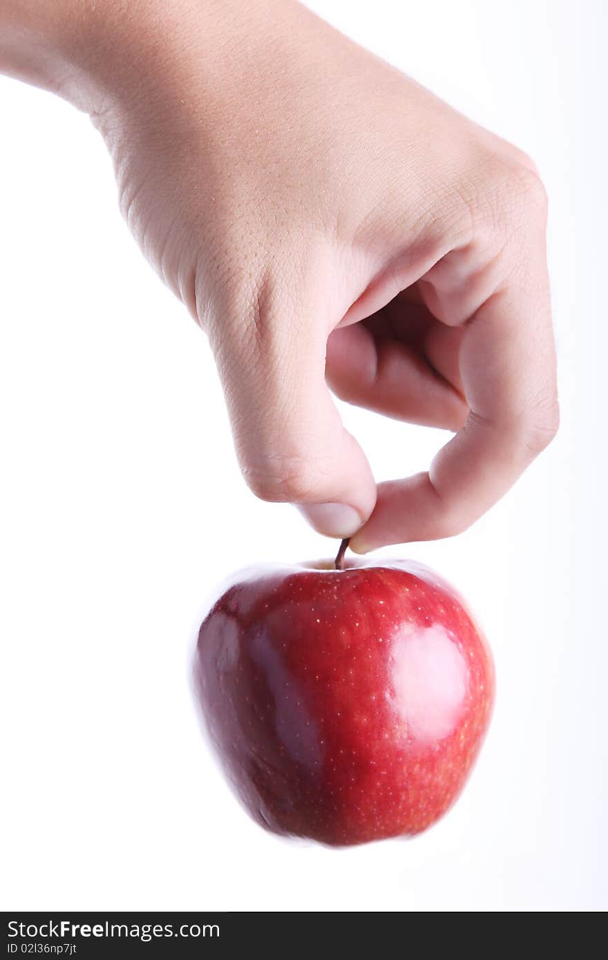 Red apple on man hand over white background. Concepts: Nutrition, Food, Health & Wellness