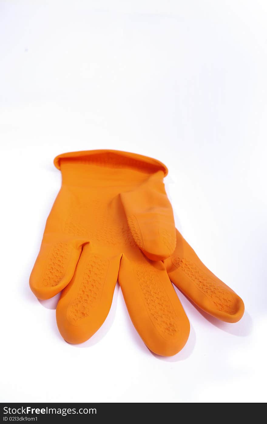 Orange single glove on the white. Orange single glove on the white.