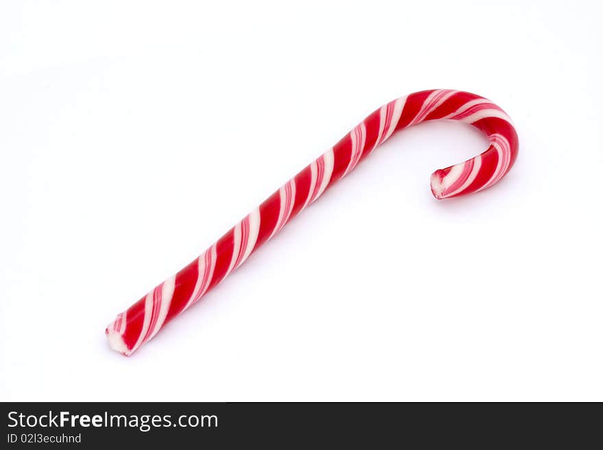 Pink stripy candy cane isolated on a white background. Pink stripy candy cane isolated on a white background