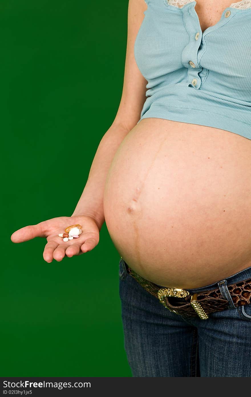 Photo of pregnant woman and many pills in hand. Photo of pregnant woman and many pills in hand