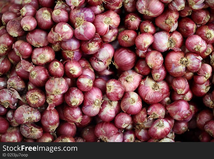 Red shallots on a market table