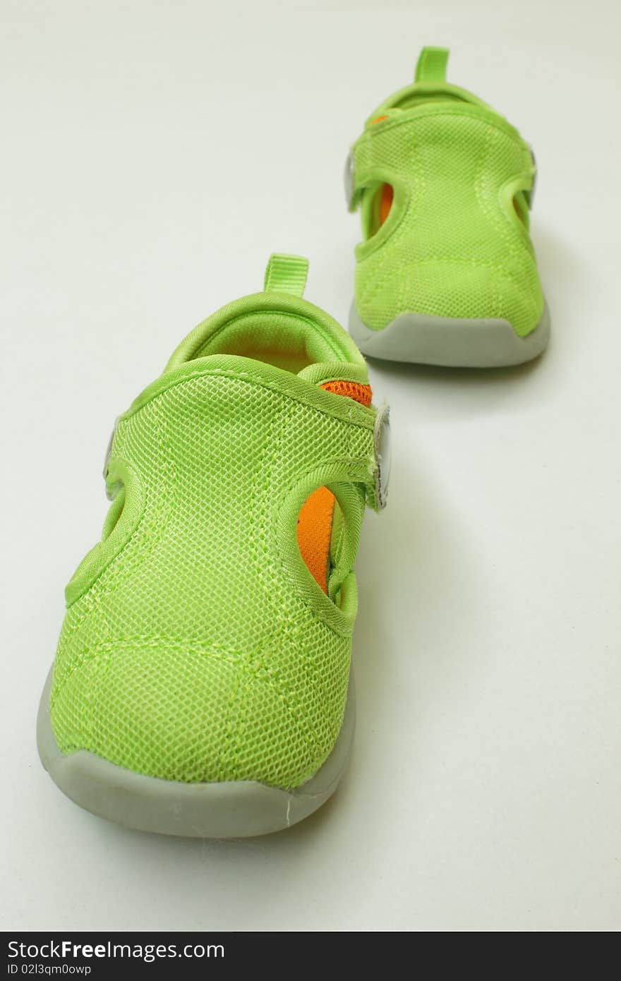 A pair of green kid shoes,isolated in the white background. A pair of green kid shoes,isolated in the white background