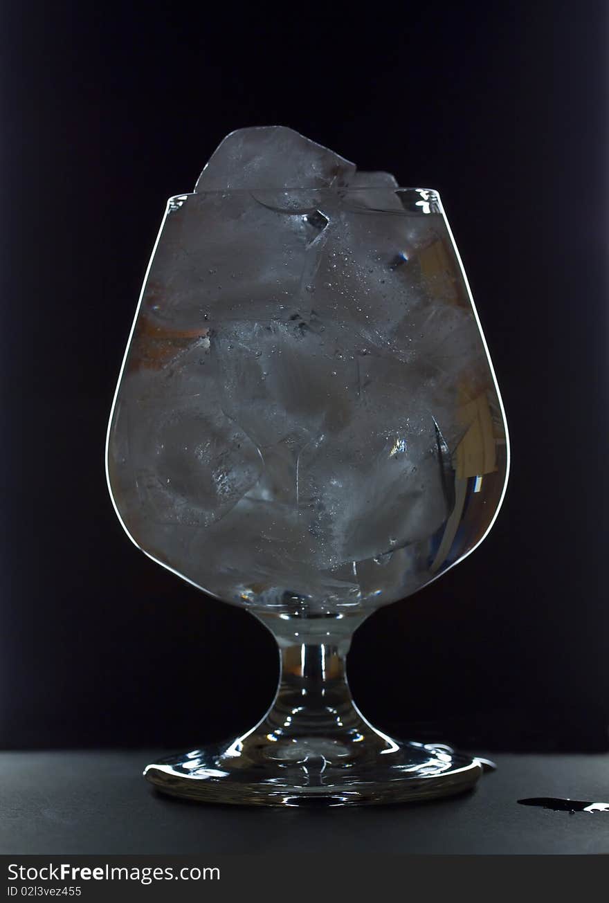 Transparent wineglass with ice and water