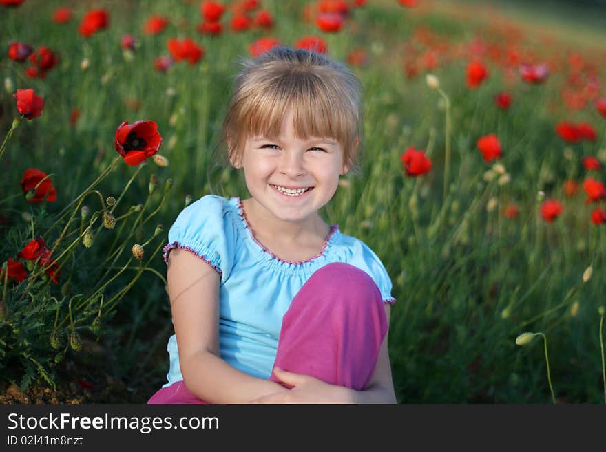 Blond girl on the field of red poppies. Blond girl on the field of red poppies.