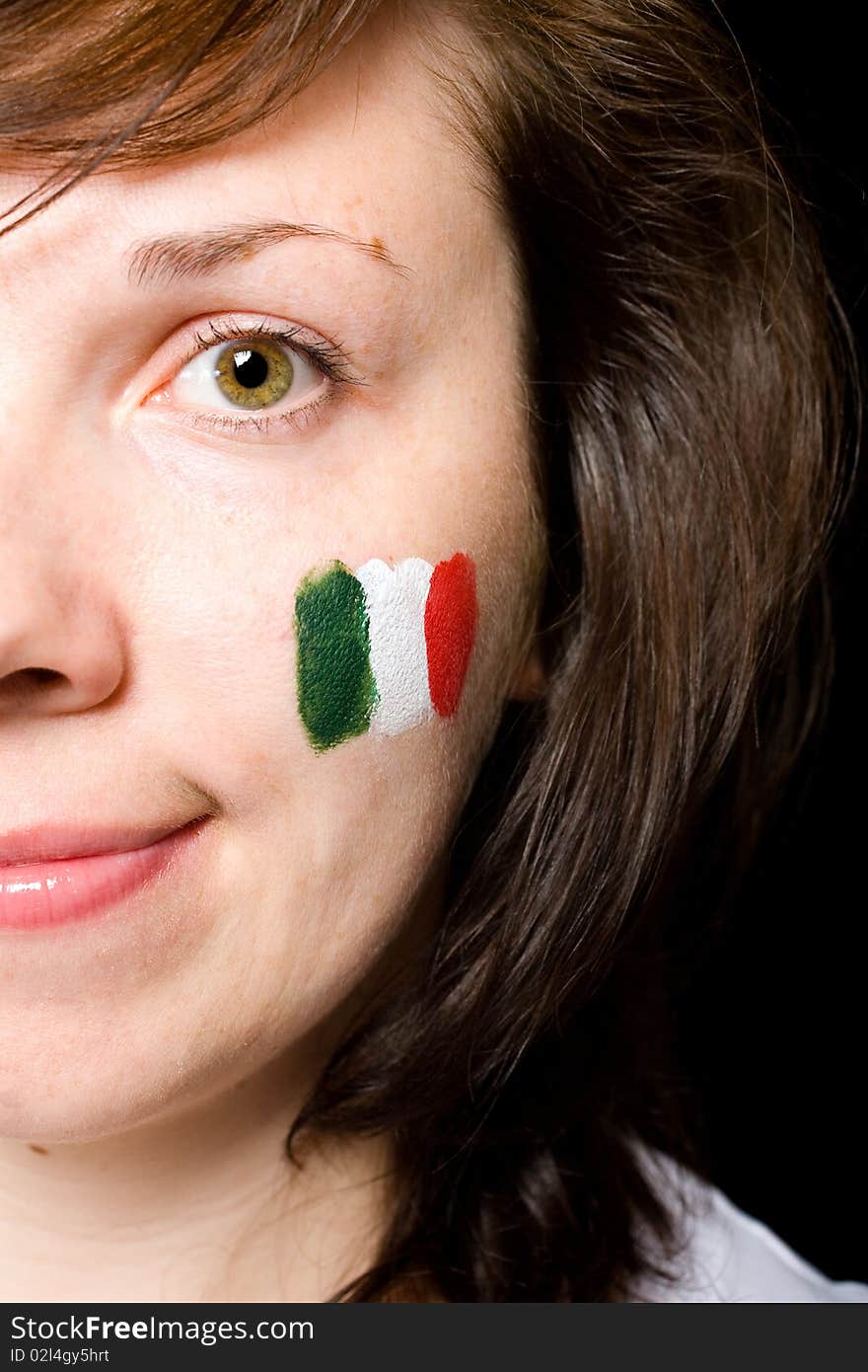 Italian team supporter with flag painted on her cheek, studio shoot isolated on black background. Italian team supporter with flag painted on her cheek, studio shoot isolated on black background