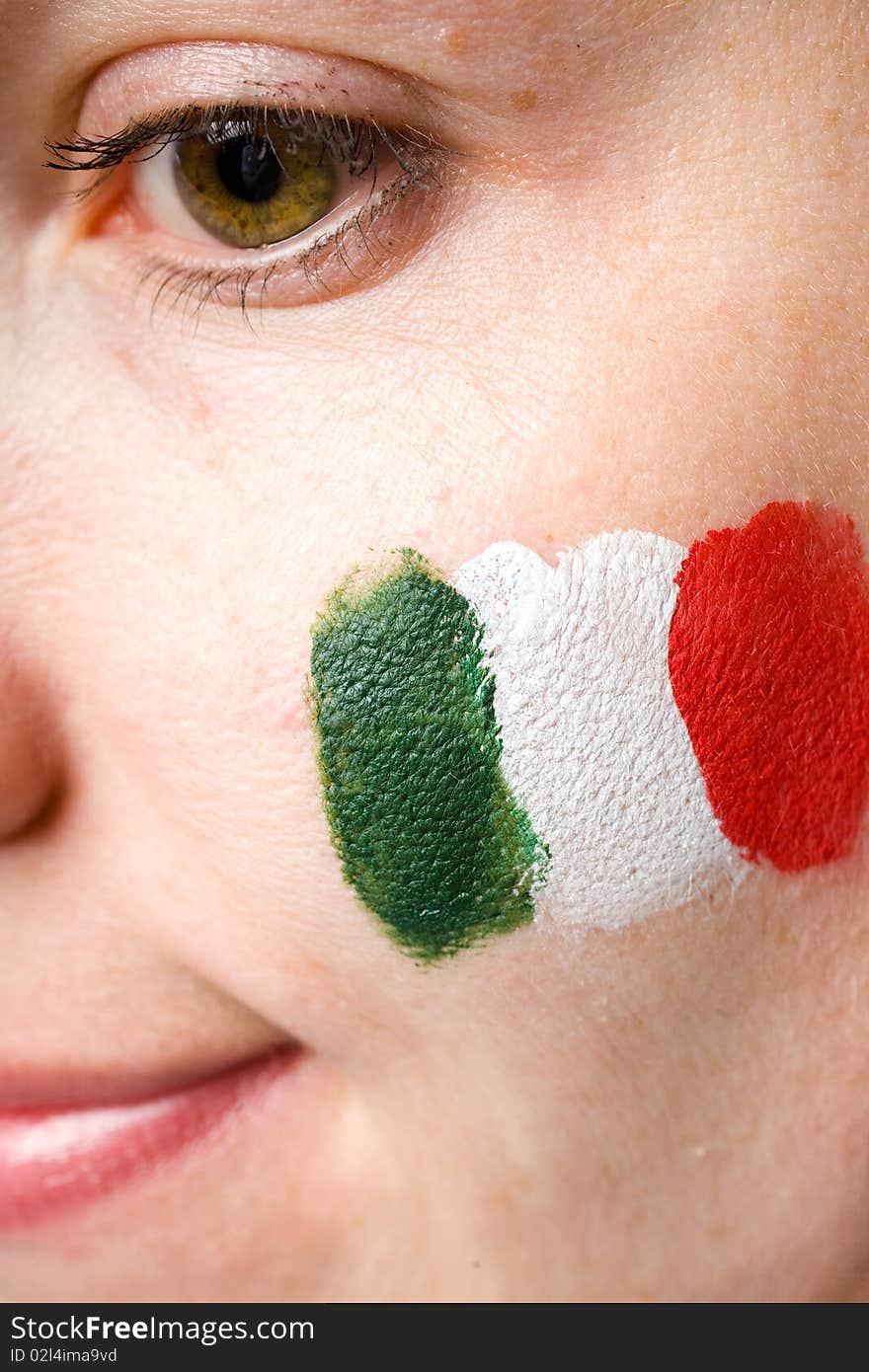 Italian team supporter with flag painted on her cheek, studio shoot isolated on black background. Italian team supporter with flag painted on her cheek, studio shoot isolated on black background