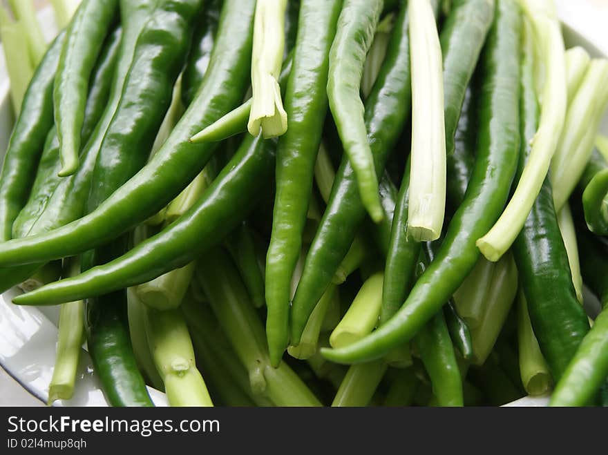 Long, green pepper, cleaned, and in the bowl, the light glowing moisture. They're waiting for people to make into delicious food. Long, green pepper, cleaned, and in the bowl, the light glowing moisture. They're waiting for people to make into delicious food.