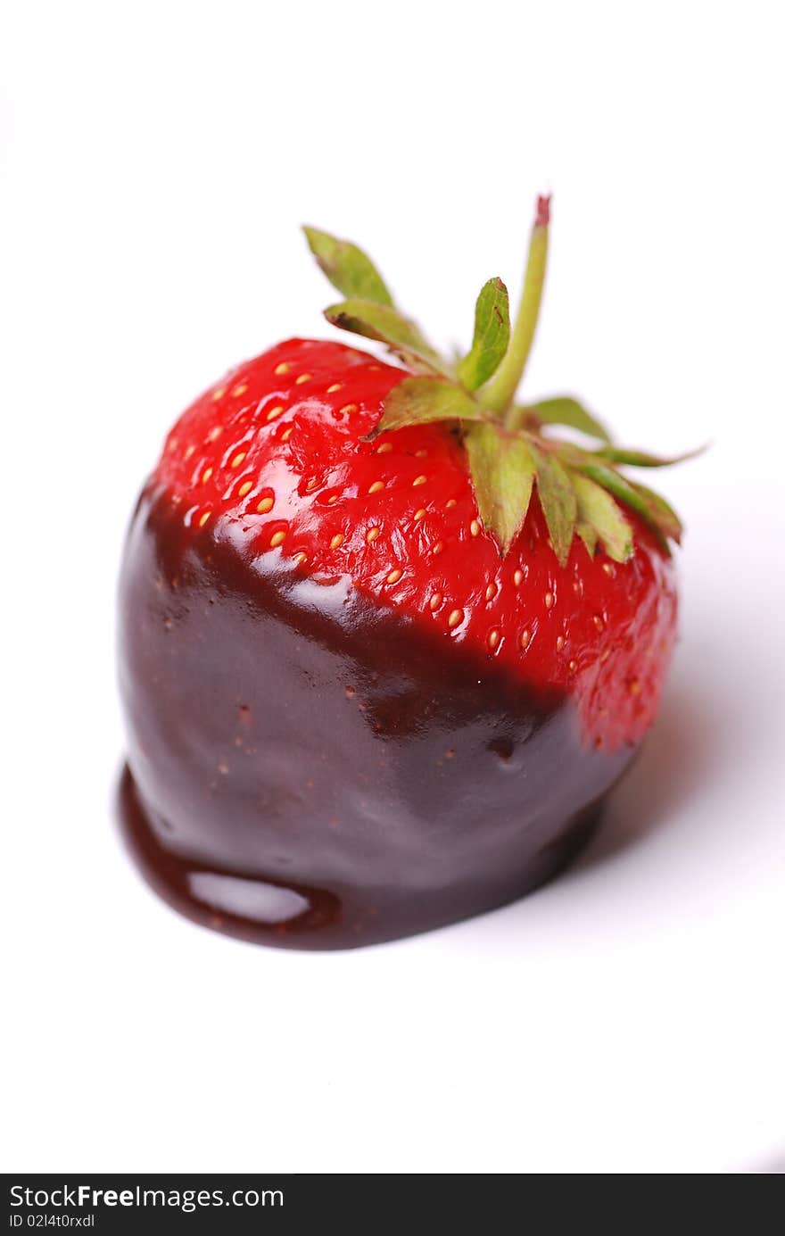 Strawberry dipped in melting dark chocolate. Strawberry dipped in melting dark chocolate