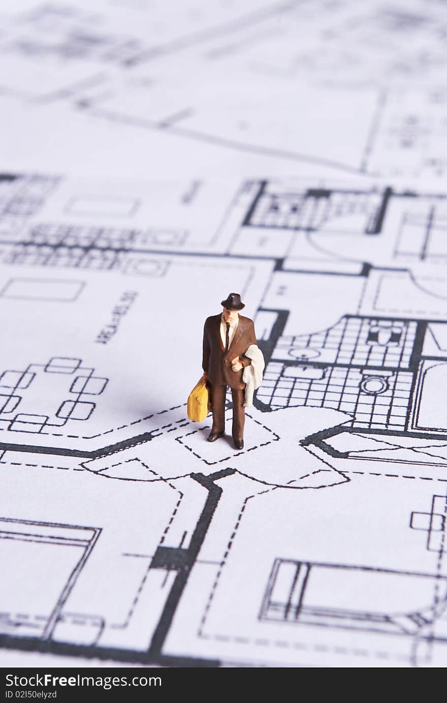 Miniature man on plans document