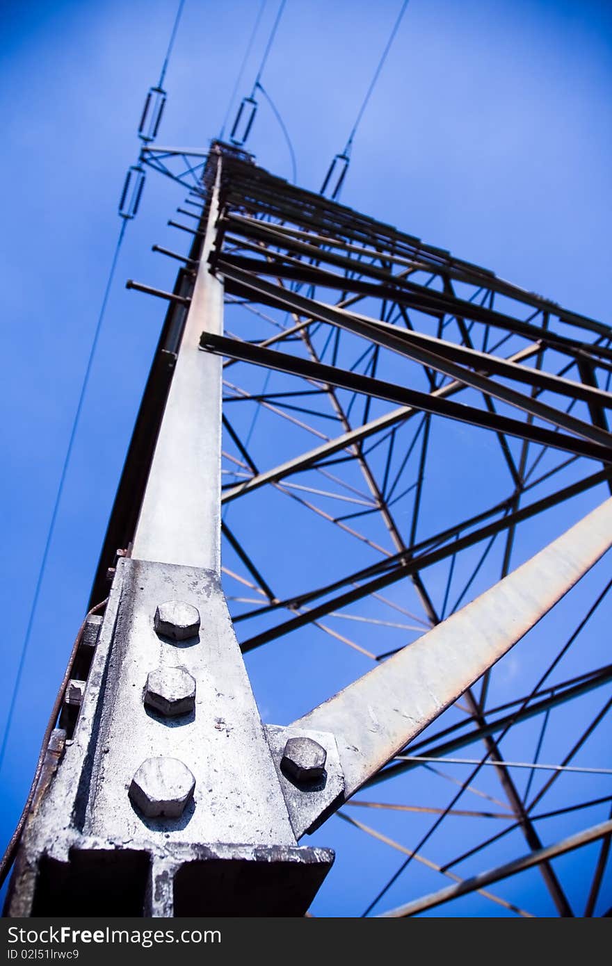 Silhouette of electricity pylon and blue sky