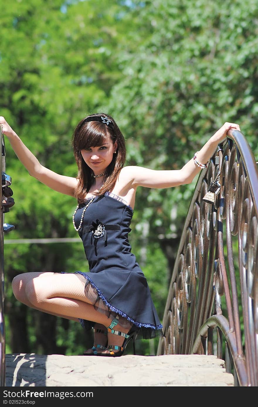 The young woman poses in the park in the summer