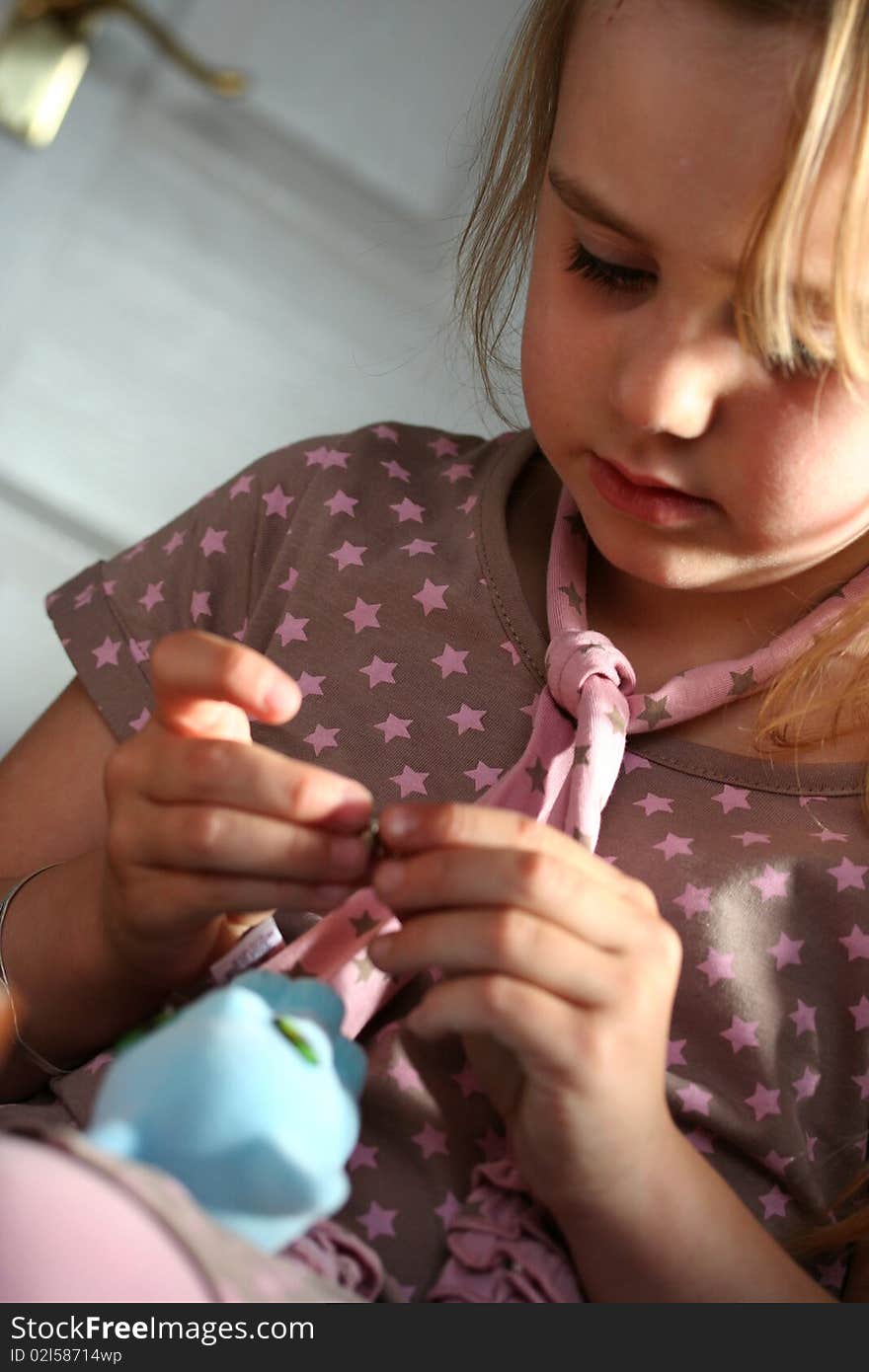 A young girl playing with her brand new birthday present. A young girl playing with her brand new birthday present