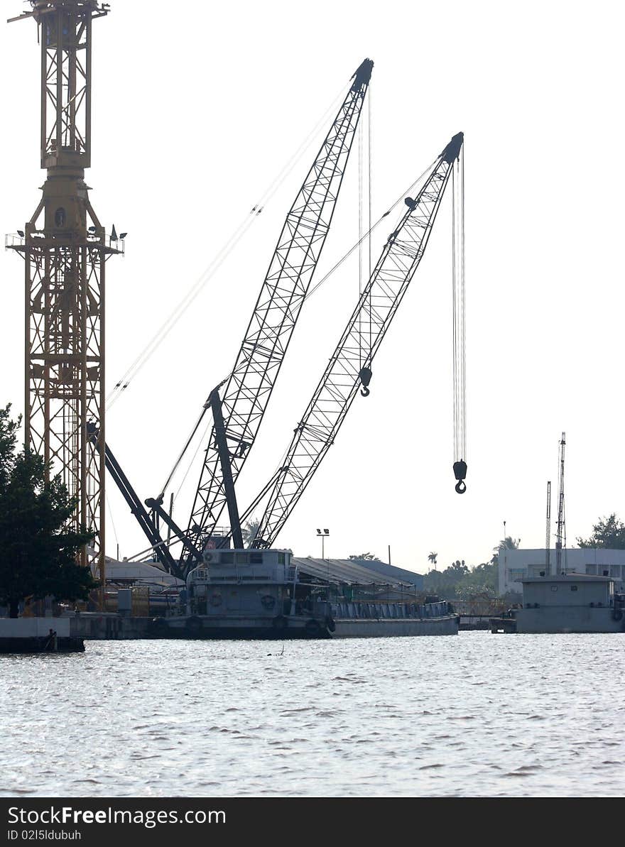 Industrial cranes in the dock by the sea. Industrial cranes in the dock by the sea