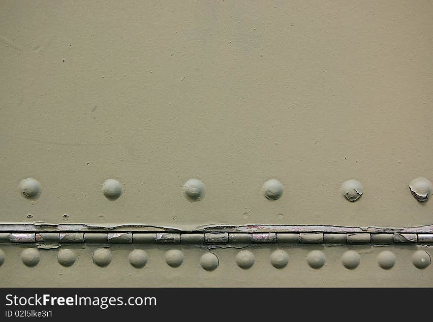 The riveted covering of a fuselage of the old military plane. The riveted covering of a fuselage of the old military plane.