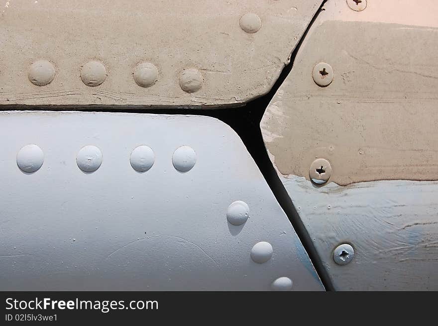 The riveted covering of a fuselage of the old military plane. The riveted covering of a fuselage of the old military plane.