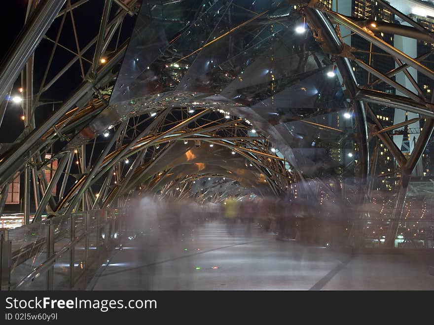 A busy pedestrian bridge at night. A busy pedestrian bridge at night.