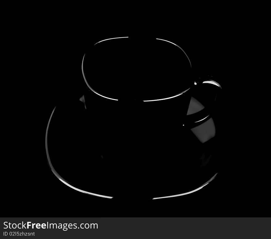 The silhouette black mug on black background