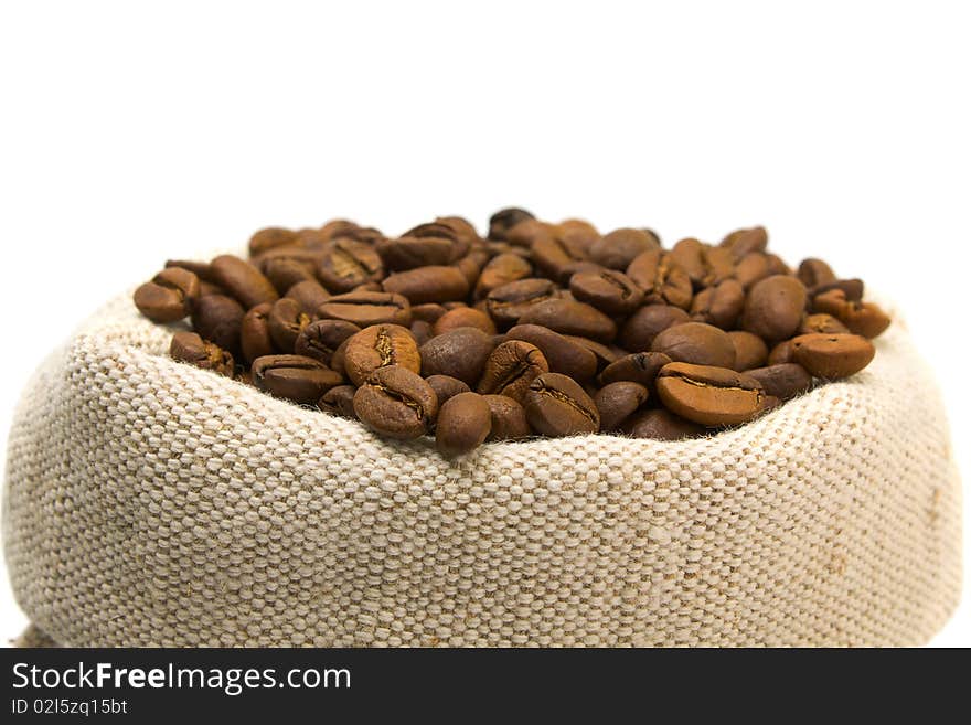 Coffee beans and burlap sack isolated on white