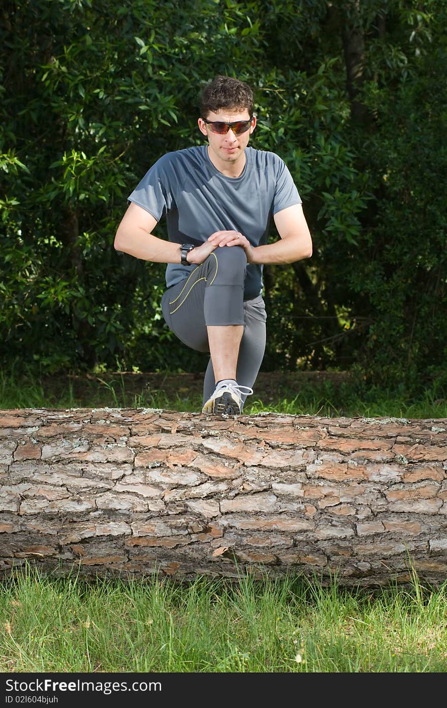 A middle age man making stretching movements before run