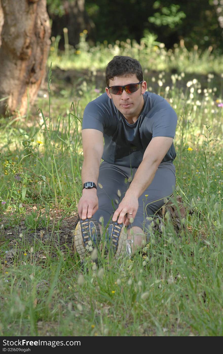 A middle age man making stretching movements before run