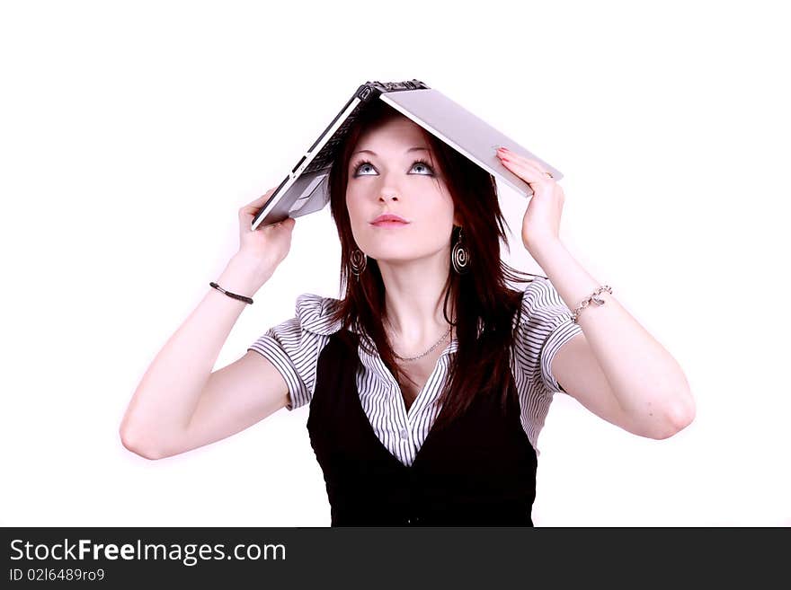 An attractive woman in office environment covering her head with a laptop. An attractive woman in office environment covering her head with a laptop.