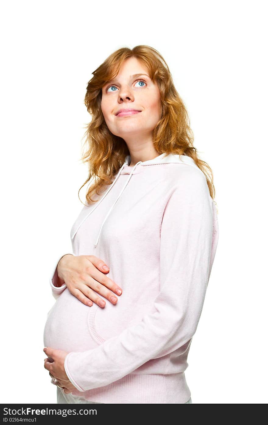 Young pregnant woman holding her hands on her tummy