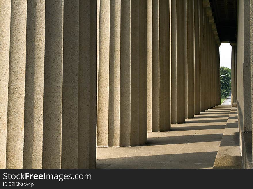 Classical style columns in ionic order on exterior of modern windowed building. Classical style columns in ionic order on exterior of modern windowed building.