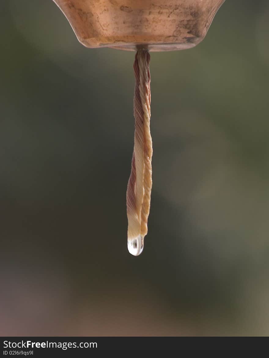 A bell pouring water on a hindu shrine.