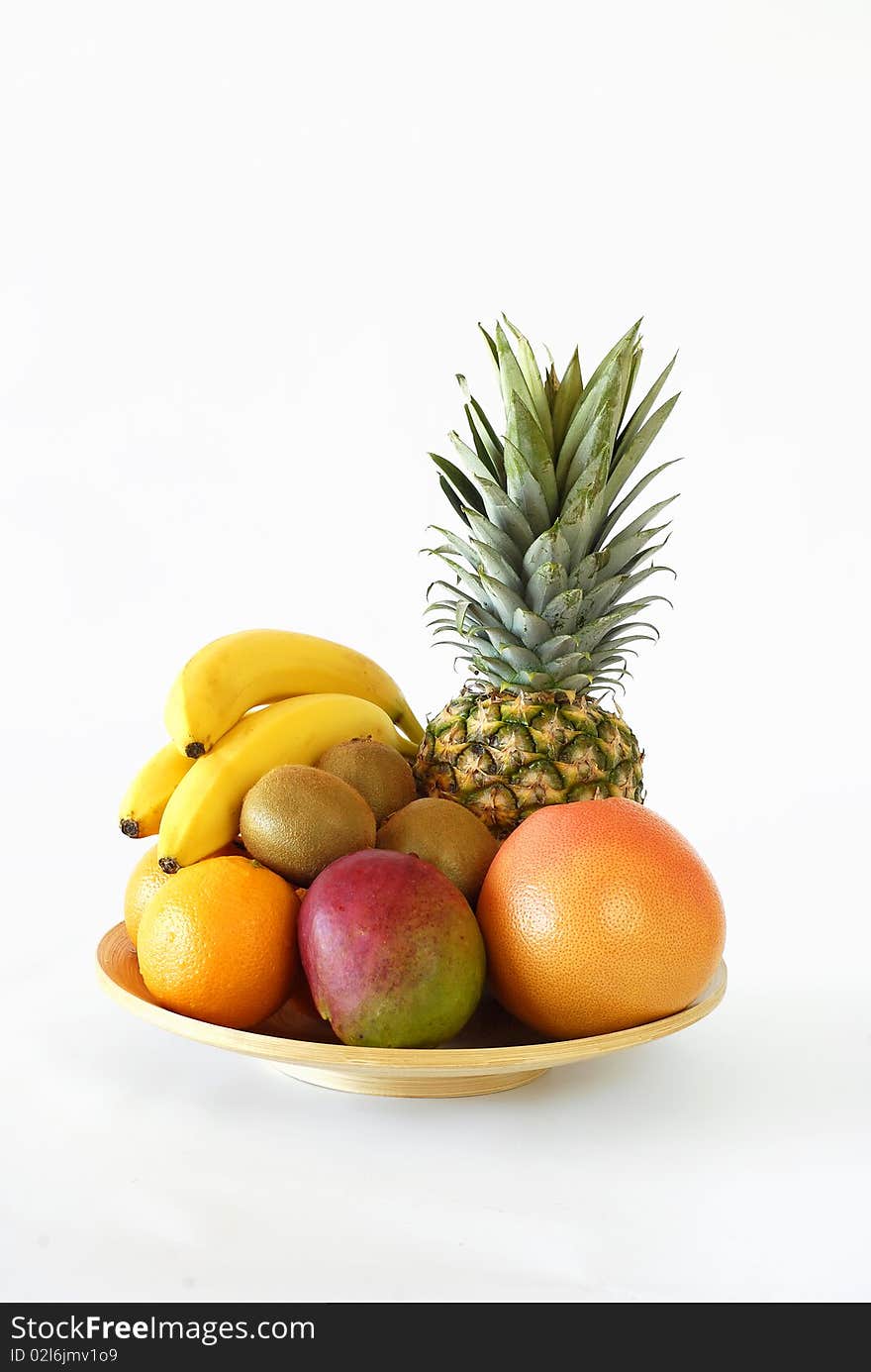 Plate of fruit noon on the white background. Plate of fruit noon on the white background