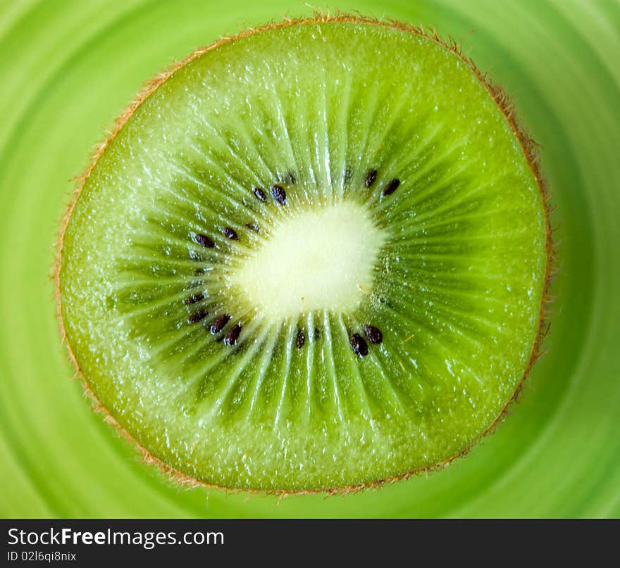 Cuted kiwi on a green plate