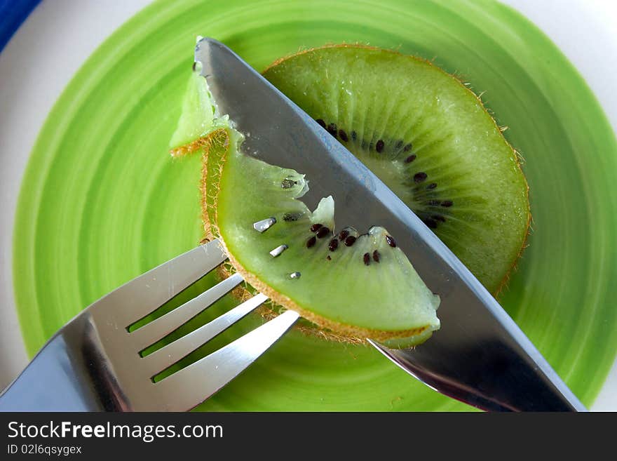 Kiwi cut with a knife on a plate